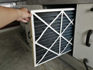 Minnesota Homeowners: 6 Costly Problems and Quick Fixes 5 a hand opening a dirty air filter